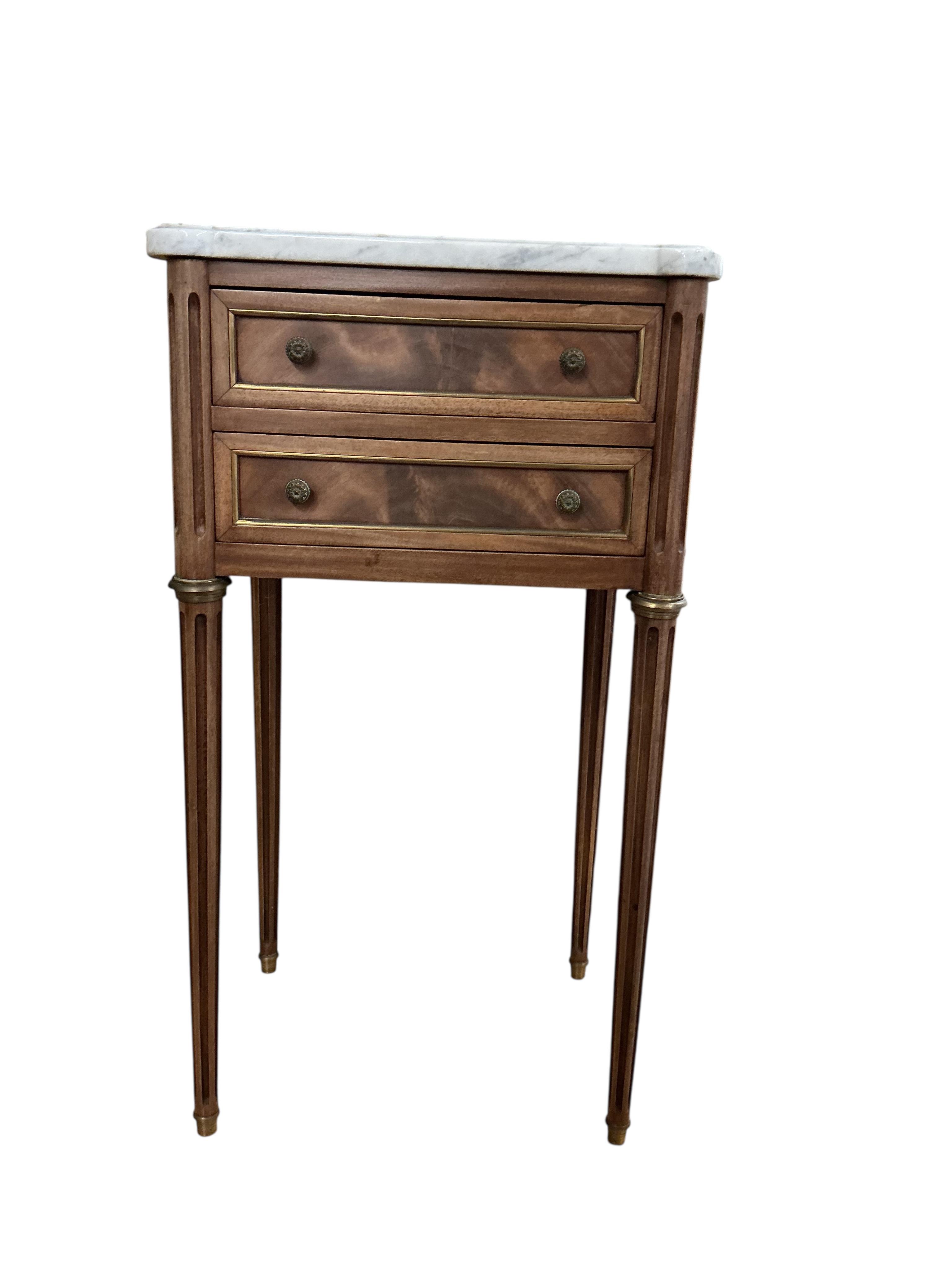 A pair of French brass mounted mahogany marble topped two drawer bedside chests, width 38cm, depth 30cm, height 68cm